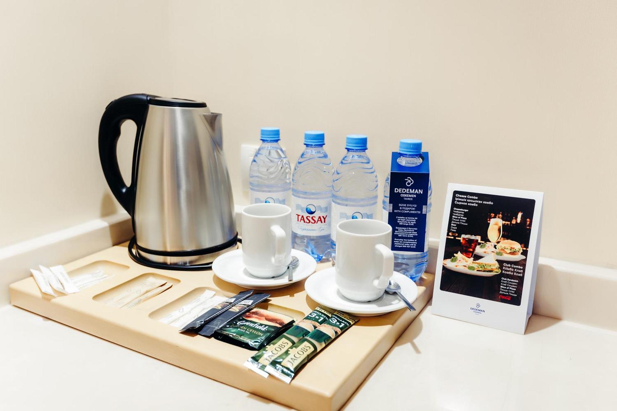 Dedeman Oskemen Tavros Hotel Ust-Kamenogorsk Exterior photo A kettle and bottled water in a hotel room