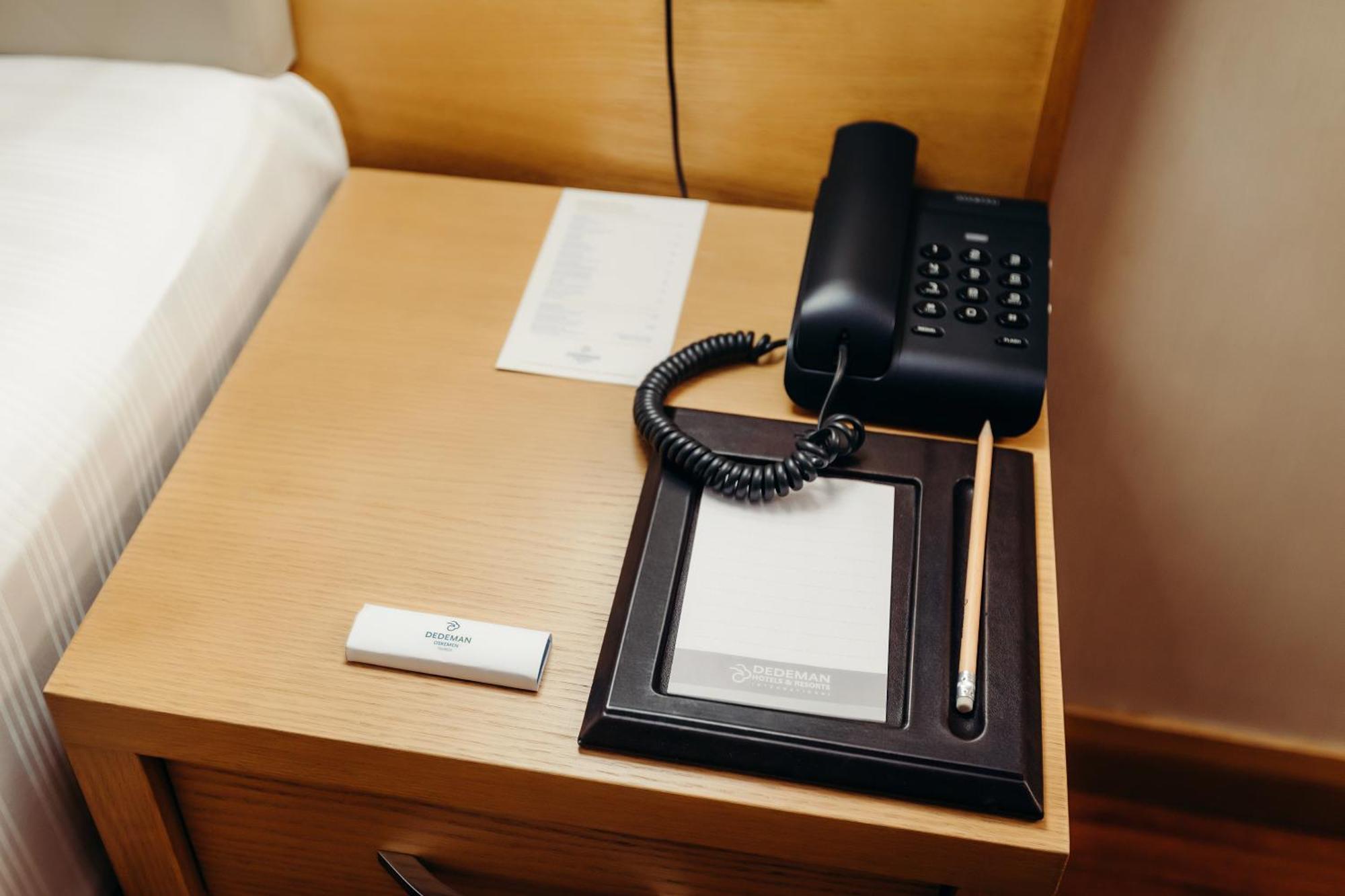 Dedeman Oskemen Tavros Hotel Ust-Kamenogorsk Room photo A telephone in a hotel room